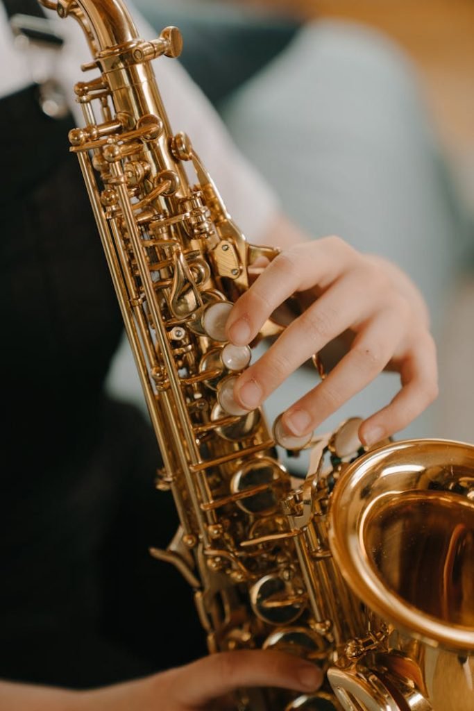 Close-up of a child playing a saxophone, highlighting musical details.