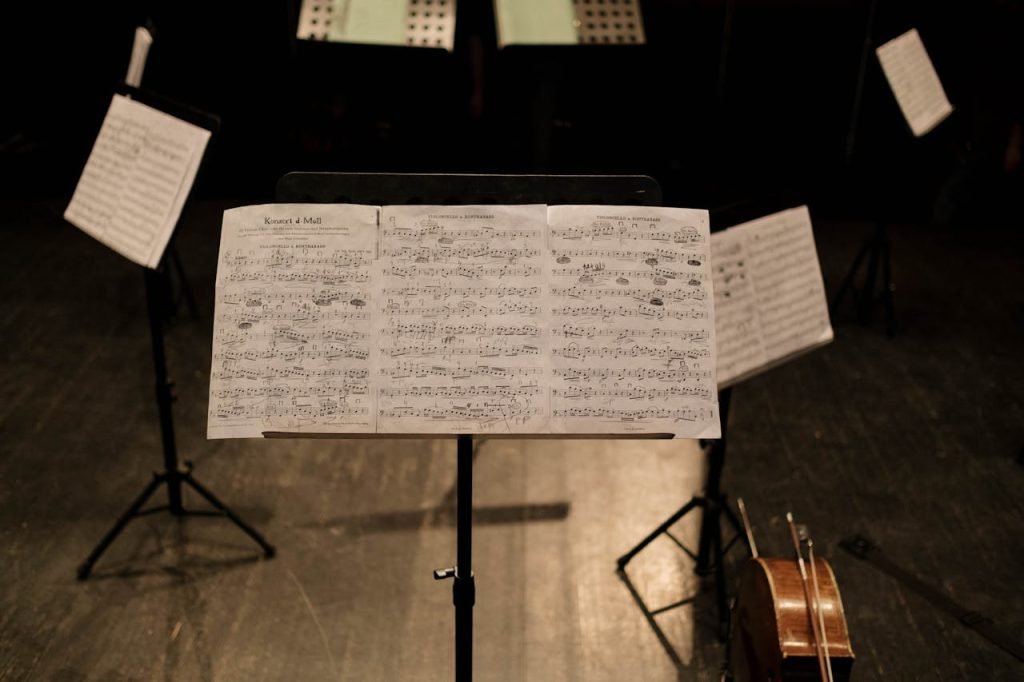 Close-up of sheet music on a stand in an empty music hall.